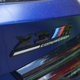 A photo of a blue 2022 BMW X3 M Competition.